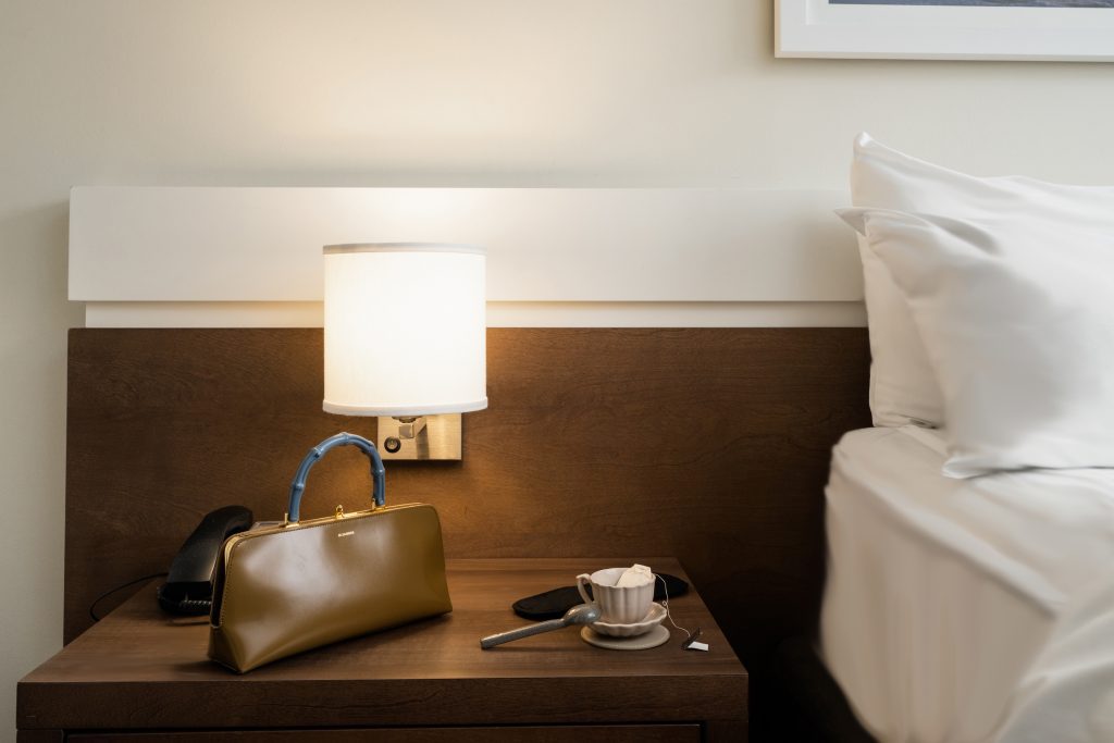 2170 Lincoln Montreal Hotel Room Night Stand with cup of tea and designer bag