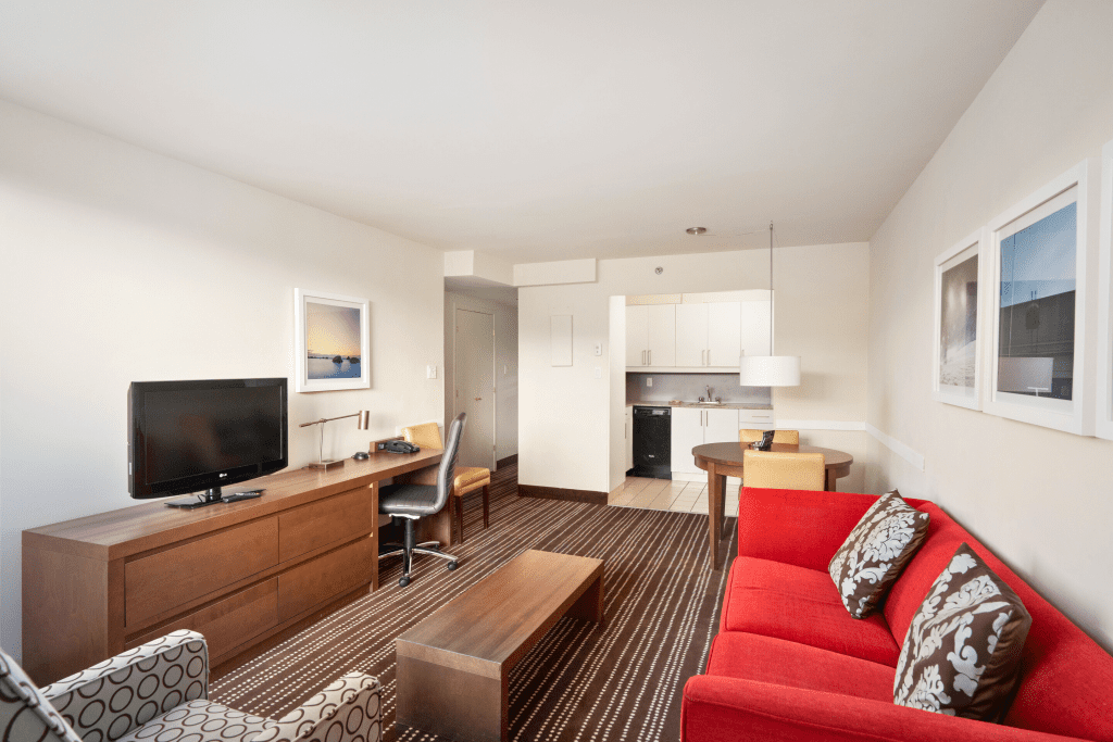 2170 Lincoln Montreal Hotel Two Bedroom Suite Seating Area with view of kitchen and TV